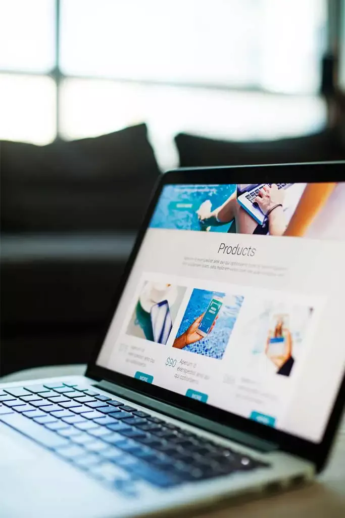A close-up of a laptop screen displaying a clean, modern e-commerce products page.